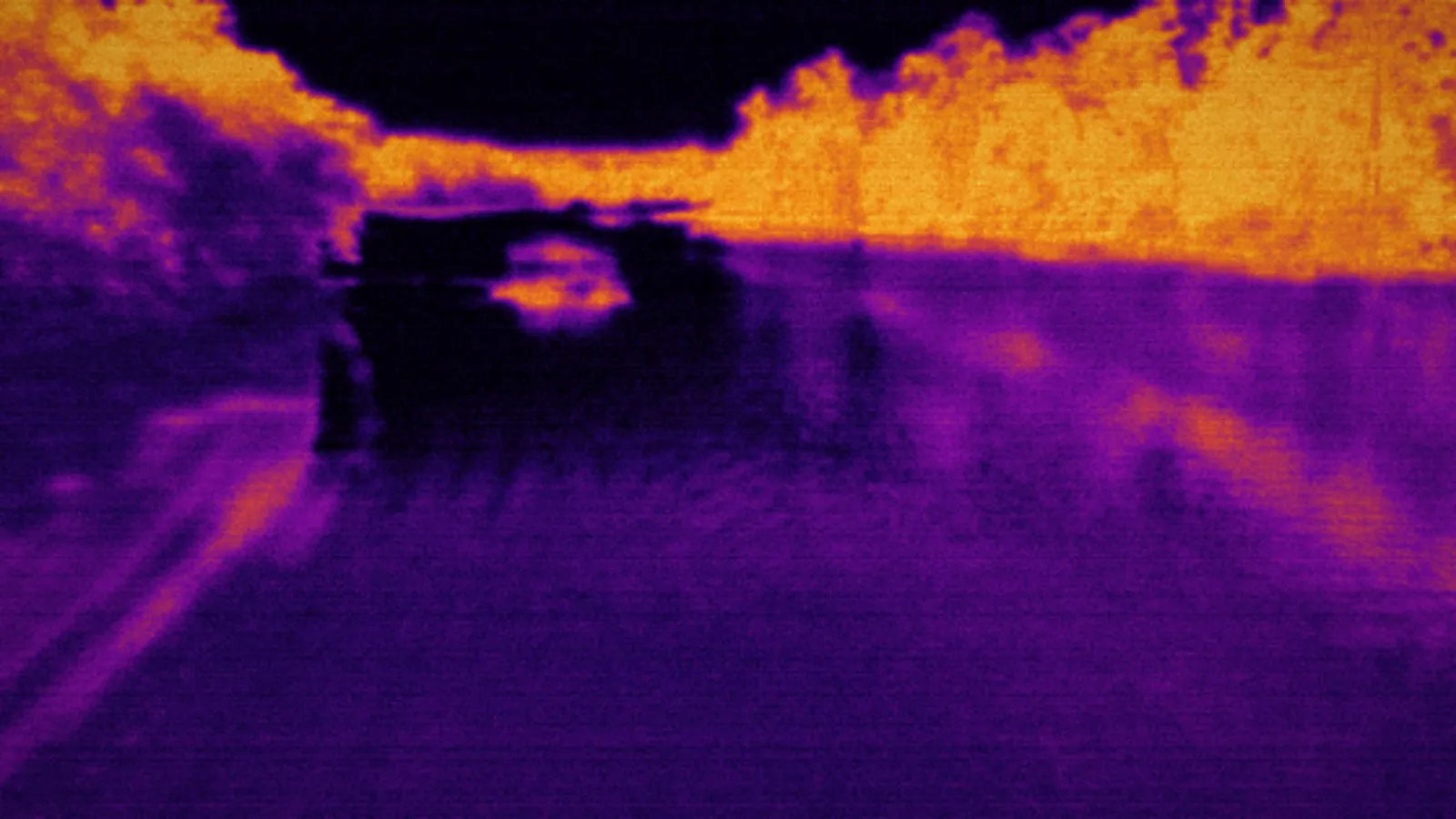 Ironbow thermal view of the same creek bottom — banks glowing warm, water reading cold and black